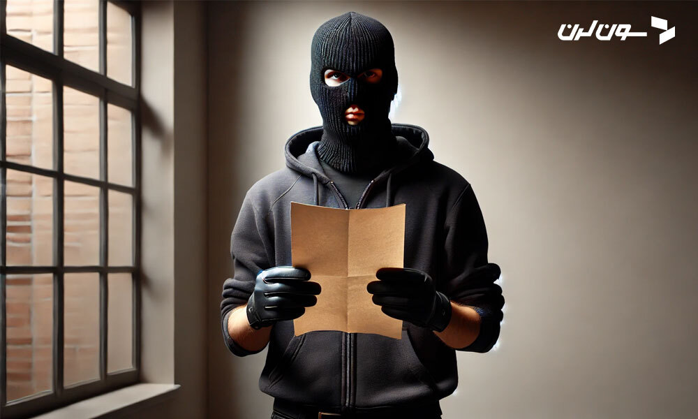 A masked thief wearing dark clothing holds a piece of paper in a dimly lit room.